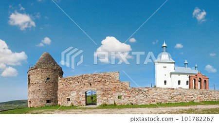Summer panorama view of old christian cloister on hill top and village behind (in Ternopilska Region, Ukraine). Summer panorama view of old christian cloister on hill top and village behind (in Ternopilska Region, Ukraine). 101782267