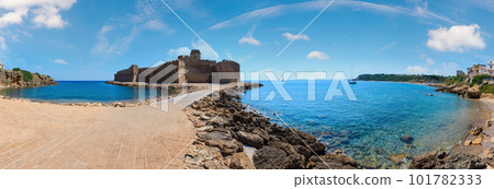 Aragonese castle of Le Castella, a fortress on a small islet on Ionian Sea coast, overlooking the Costa dei Saraceni near Capo Rizzuto, Calabria, Italy. People unrecognizable. 101782333