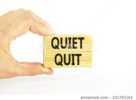 Quiet quit symbol. Concept words Quiet quit on wooden blocks. Beautiful white table white background. Businessman hand. Business and quiet quit concept. Copy space. Quiet quit symbol. Concept words Quiet quit on wooden blocks. Beautiful white table white background. Businessman hand. Business and quiet quit concept. Copy space. 101783162