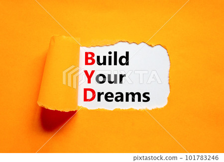 BYD build your dreams symbol. Concept words BYD build your dreams on white paper on a beautiful orange background. Business and BYD build your dreams concept. Copy space. 101783246
