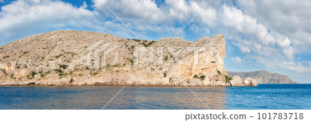 Summer rocky coastline and military base on rock top  (Alchak Cape; Sudak Town environs, Crimea, Ukraine). 101783718