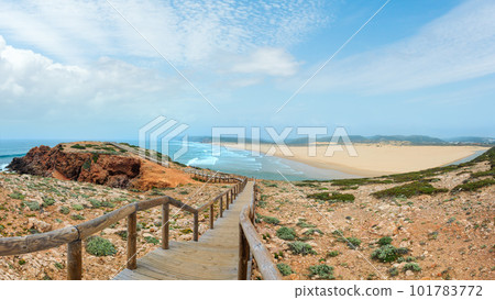 Summer Atlantic coast and lookout point at sandy beach Praia da Bordeira near river estuary. Misty view (Carrapateira, Algarve, Portugal). Summer Atlantic coast and lookout point at sandy beach Praia da Bordeira near river estuary. Misty view (Carrapateira, Algarve, Portugal). 101783772