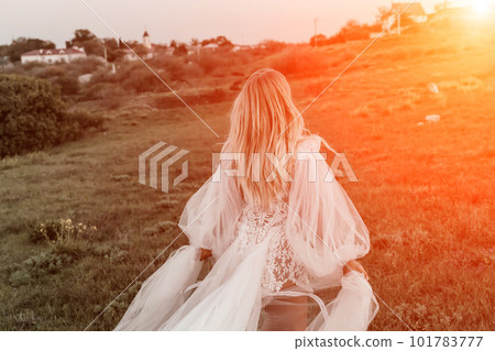 beautiful young bride in a field at sunset beautiful young bride in a field at sunset 101783777