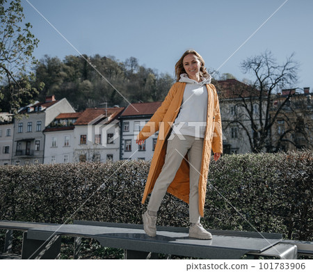 A beautiful young stylish woman walking in the city. Spring mood, dreaming and waiting, a lifestyle concept A beautiful young stylish woman walking in the city. Spring mood, dreaming and waiting, a lifestyle concept 101783906