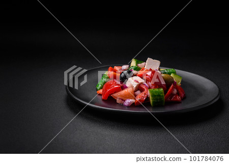 Delicious, fresh Greek salad with feta cheese, olives, tomatoes and cucumbers 101784076