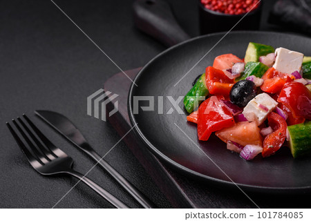 Delicious, fresh Greek salad with feta cheese, olives, tomatoes and cucumbers 101784085