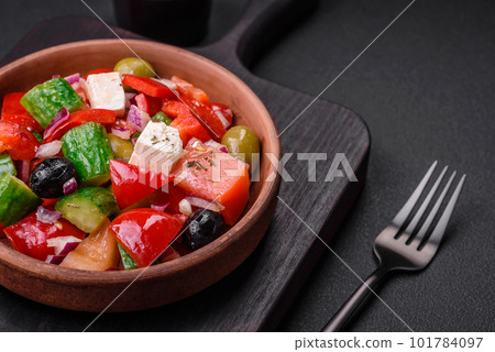 Delicious, fresh Greek salad with feta cheese, olives, tomatoes and cucumbers Delicious, fresh Greek salad with feta cheese, olives, tomatoes and cucumbers 101784097