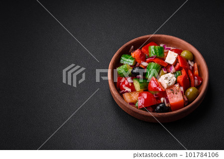 Delicious, fresh Greek salad with feta cheese, olives, tomatoes and cucumbers 101784106
