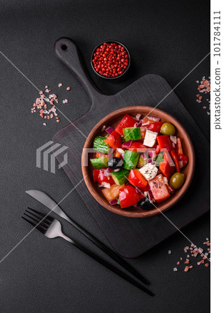 Delicious, fresh Greek salad with feta cheese, olives, tomatoes and cucumbers 101784111