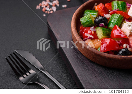 Delicious, fresh Greek salad with feta cheese, olives, tomatoes and cucumbers 101784113