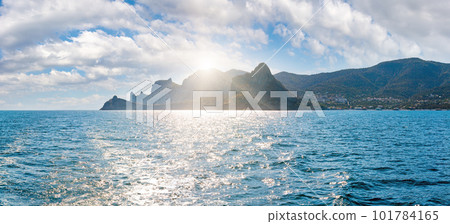 Scintillate sea surface and evening sunshiny summer rocky coastline, Crimea, Ukraine. 101784165