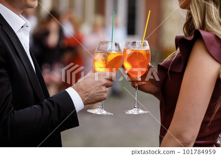 young couple drinking a cocktail.hands of two people holding cocktails. alcoholic cocktails. soft drinks young couple drinking a cocktail.hands of two people holding cocktails. alcoholic cocktails. soft drinks 101784959