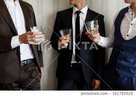 stylish friends businessmen in suits toasting with glasses of whiskey indoors, closeup. groom's morning 101785028