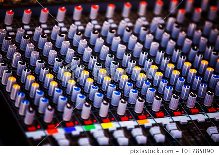 Concert sound mixer panel with volume regulators. Professional audio and light equipment for sound recording studio, live music broadcasting, television, party. mixing console. audio signals 101785090