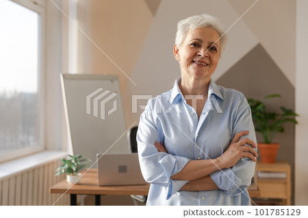 Portrait of confident stylish european middle aged senior woman at workplace. Stylish older mature 60s gray haired lady businesswoman in modern office. Boss leader teacher professional worker Portrait of confident stylish european middle aged senior woman at workplace. Stylish older mature 60s gray haired lady businesswoman in modern office. Boss leader teacher professional worker 101785129