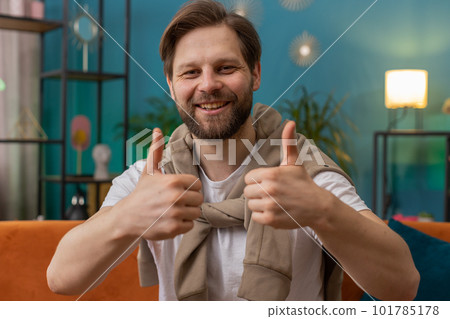 Happy Caucasian man looking approvingly at camera showing thumbs up, like positive sign, good news 101785178