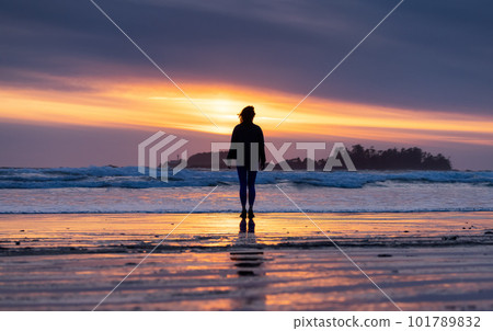 Adventurous Woman Standing on the Sandy Beach on the West Coast of Pacific Ocean Adventurous Woman Standing on the Sandy Beach on the West Coast of Pacific Ocean 101789832