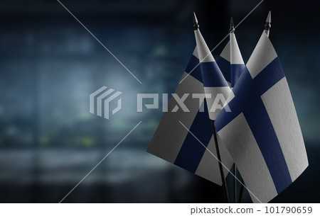 Small flags of the Finland on an abstract blurry background 101790659
