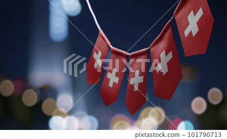 A garland of Switzerland national flags on an abstract blurred background A garland of Switzerland national flags on an abstract blurred background 101790713