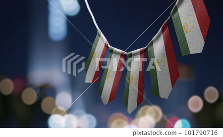 A garland of Tajikistan national flags on an abstract blurred background A garland of Tajikistan national flags on an abstract blurred background 101790716
