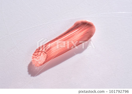Three strokes of lip gloss on a beige background. 101792796