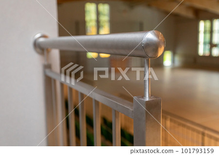 Handrail at the top of the balustrade made of non-wooden steel fixed to the wall. Handrail at the top of the balustrade made of non-wooden steel fixed to the wall. 101793159