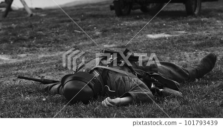 Re-enactor Dressed As German Wehrmacht Soldier Lies Slain In Reconstruction Of Battles World War Ii. German Infantry Soldier In World War Ii. Reconstruction. Black And White Video 101793439