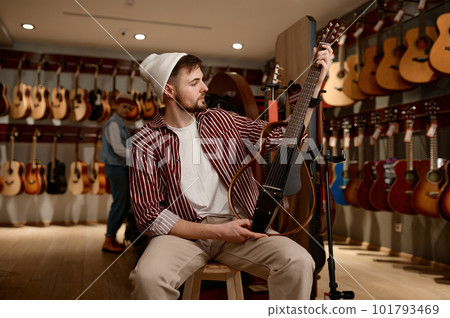 Young man choosing an electric guitar 101793469