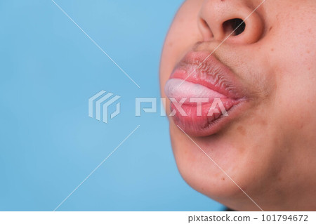 Young woman chewing gum and blowing bubble gum on blue background. Young woman chewing gum and blowing bubble gum on blue background. 101794672