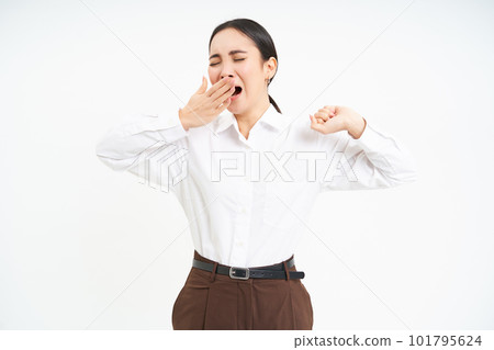 Tired asian corporate woman, yawns and stretches her back from fatigue after work, isolated on white background Tired asian corporate woman, yawns and stretches her back from fatigue after work, isolated on white background 101795624