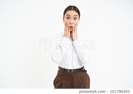 Corporate woman looks amazed, holds hands near face with surprised face expression, isolated on white background Corporate woman looks amazed, holds hands near face with surprised face expression, isolated on white background 101796303