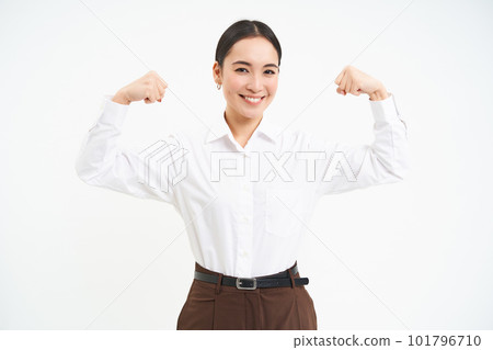 Business and corporate women. Strong and successful asian woman entrepreneur, shows biceps, flexing muscles, smiling pleased, white background Business and corporate women. Strong and successful asian woman entrepreneur, shows biceps, flexing muscles, smiling pleased, white background 101796710