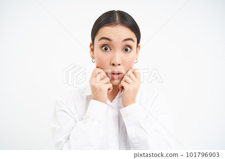 Portrait of asian businesswoman looks surprised, amazed reaction on advertisement, stands over white background 101796903