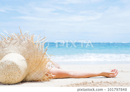 Woman lies on the white sand on the beach Woman lies on the white sand on the beach 101797848