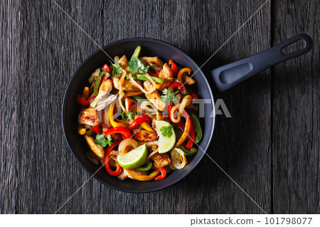 chicken fajitas with bell peppers, onion, spices 101798077