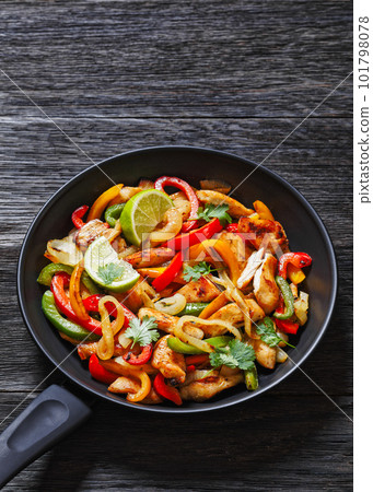 chicken fajitas with bell peppers, onion, spices 101798078
