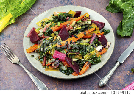 Vegetarian warm salad of stewed vegetables and chard leaves. Vegetarian warm salad of stewed vegetables and chard leaves. 101799112