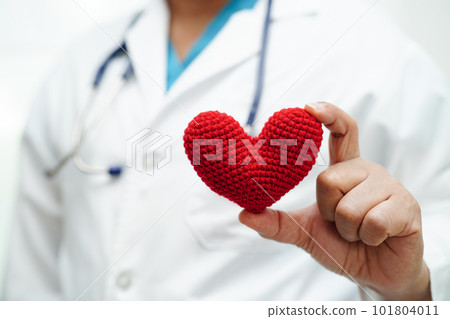 Asian woman doctor holding red heart for health in hospital. 101804011