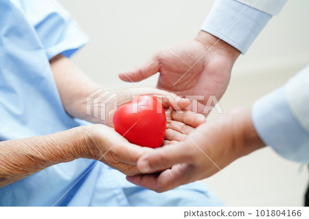 Asian woman doctor holding red heart for health in hospital. Asian woman doctor holding red heart for health in hospital. 101804166