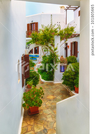 Beautiful patio in traditional Greek style, whitewashed walls and lush foliage in pots. Beautiful patio in traditional Greek style, whitewashed walls and lush foliage in pots. 101805665