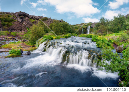 Gjain waterfall flowing with lush jungle in Pjorsardalur valley on summer at Iceland 101806410