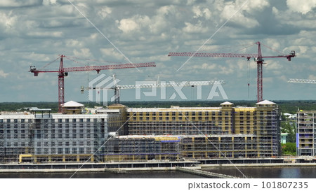Tower cranes and frame structure of high residential apartment buildings at construction site. Real estate development 101807235