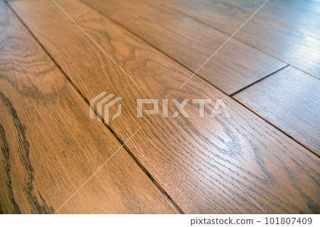 Natural light brown wooden parquet floor boards. Sunny soft yellow texture, copy space perspective background. Natural light brown wooden parquet floor boards. Sunny soft yellow texture, copy space perspective background. 101807409