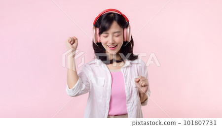 Smile pretty asian model person listen music song and enjoy dance with wireless headphone online audio radio sound. Positive fun exited joyful youth female woman on pink isolated background studio Smile pretty asian model person listen music song and enjoy dance with wireless headphone online audio radio sound. Positive fun exited joyful youth female woman on pink isolated background studio 101807731