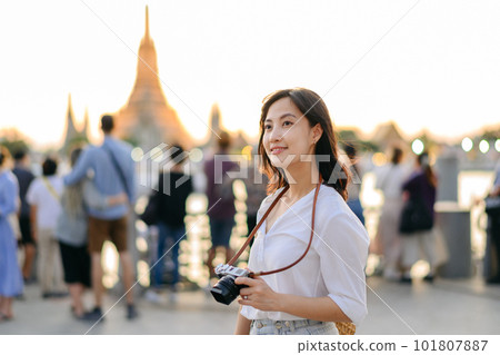 Portrait young beautiful asian woman smiling while travel at Wat Arun sunset view point, Bangkok, Thailand. Portrait young beautiful asian woman smiling while travel at Wat Arun sunset view point, Bangkok, Thailand. 101807887