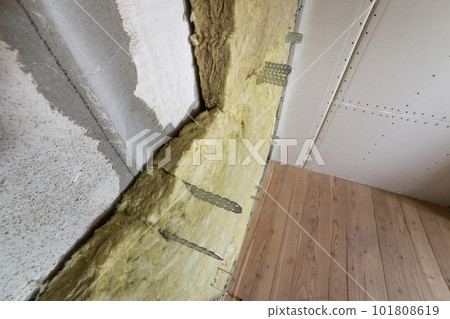 Metal frame for future walls with drywall plates insulated with rock wool and fiberglass insulation staff for cold barrier. Comfortable warm home, economy, construction and renovation concept. 101808619