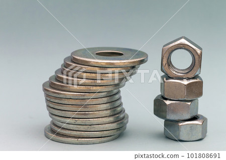 Joiner's accessories. Stacks of metal screw washers and nuts iso Joiner's accessories. Stacks of metal screw washers and nuts iso 101808691