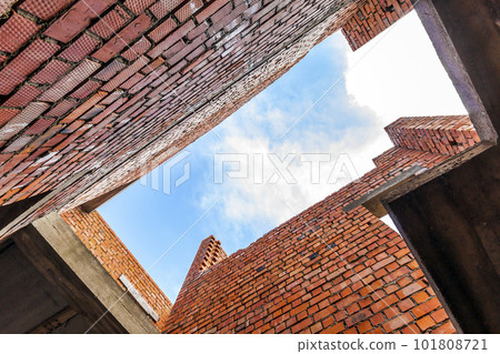 Interior of an old building under construction. Orange brick walls in a new house. 101808721
