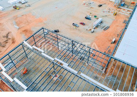 Steel truss frame construction of warehouse building as part construction site is taking place at the moment Steel truss frame construction of warehouse building as part construction site is taking place at the moment 101808936