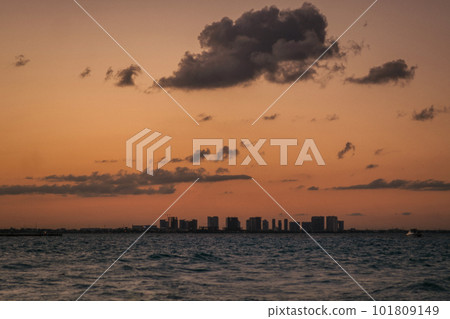 Sunrise or sunrise overlooking the sea and a line of hotels in Cancun Sunrise or sunrise overlooking the sea and a line of hotels in Cancun 101809149